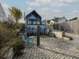 An outdoor area with a house and patio furniture at The Barn in Newport
