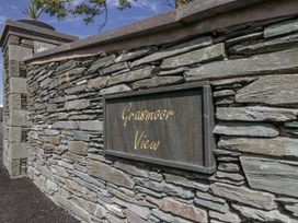 A stone wall with a sign that says Grasmoor View