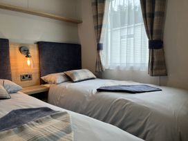 A bedroom with two beds and a window at Winscales Rest in Winscales