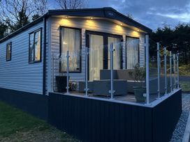 A caravan with a deck and outdoor furniture at Winscales Rest in Winscales