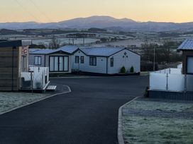 A view of mobile homes and a road with mountains in the background at Winscales Rest in Winscales
