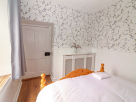A bedroom with a bed and door at The Farmhouse in Tralee, County Kerry