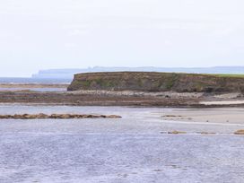 A coastal landscape with a cliff and water at The Farmhouse in Tralee, County Kerry