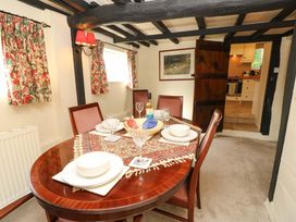 A dining room with a table set for a meal at Smugglers Cottage in New Milton