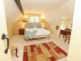A bedroom with a bed and nightstand at Smugglers Cottage in New Milton