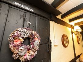 A door with a wreath in a hallway at Smugglers Cottage in New Milton