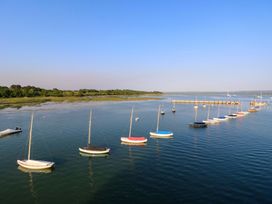 A marina with sailboats and a pier at Smugglers Cottage in New Milton