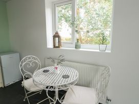A dining area with a table and chairs at Seiriol Shepherds hut Ty Croes