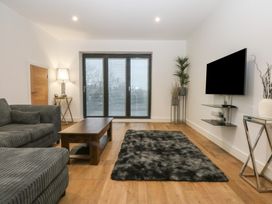 A living room with a sofa and coffee table at 2 Harbour Lights in Cemaes Bay