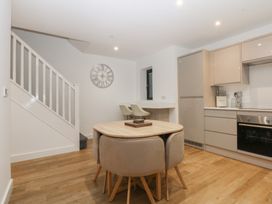 A kitchen with a dining table and chairs at 2 Harbour Lights Cemaes Bay