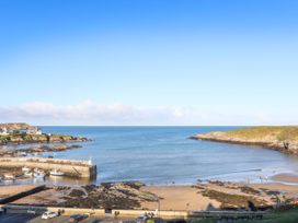A view of the beach and sea at 2 Harbour Lights in Cemaes Bay
