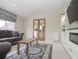 A living room with a sofa and coffee table at The Cabin in Thornton Dale