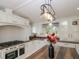 A kitchen with a countertop, oven, and storage cabinets at The Cabin in Thornton Dale