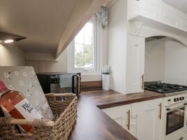 A kitchen with an oven, microwave, and countertop at The Cabin in Thornton Dale