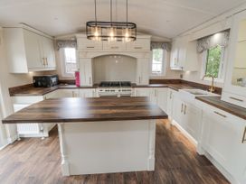 A kitchen with a counter and stove at The Cabin in Thornton Dale