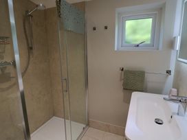 A bathroom with a shower and sink at The Roost in Whitford Nr. Colyton