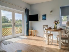 A dining area with a table and chairs at The Roost in Whitford Nr. Colyton