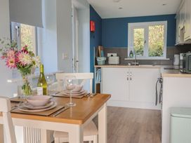 A kitchen with a dining table set at The Roost in Whitford Nr. Colyton