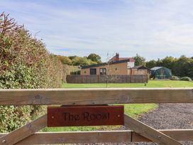 An outdoor area with a gate and house view at The Roost Whitford Nr. Colyton