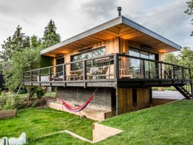 A house with a deck and hammock in the garden at The Red House in Farndon