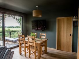 A dining room with a table and chairs at The Red House in Farndon