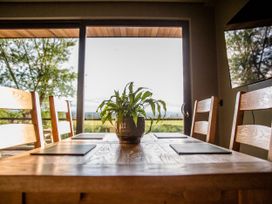 A dining room with a table and chairs at The Red House in Farndon
