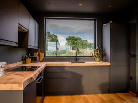 A kitchen with sink and window at The Red House in Farndon