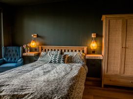 A bedroom with a bed and bedside tables at The Red House in Farndon