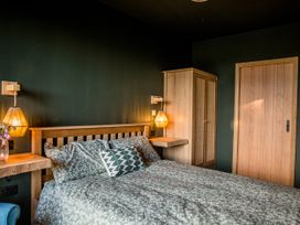 A bedroom with a bed and wardrobe at The Red House in Farndon