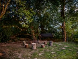 An outdoor area with tree stumps and a hammock at The Red House in Farndon