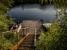 Steps leading down to a dock by the water at The Red House Farndon