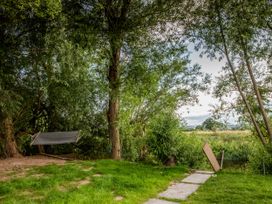 An outdoor area with a hammock and trees at The Red House in Farndon