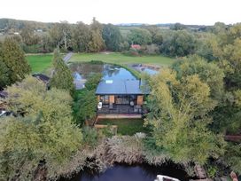 An aerial view of a building surrounded by greenery and water at The Red House in Farndon