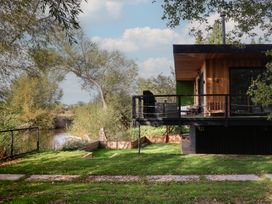 A house with a balcony overlooking a river at The Red House in Farndon
