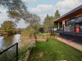 An outdoor area with a hammock and a river at The Red House in Farndon
