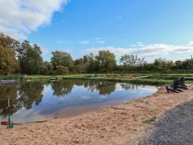 A pond surrounded by sand and chairs at The Red House in Farndon