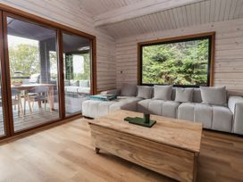 A living room with a sofa and coffee table at The Larch House in Farndon