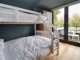 A bedroom with a bunk bed and a double bed at The Larch House Farndon