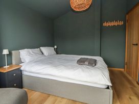 A bedroom with a bed and nightstand at The Larch House Farndon