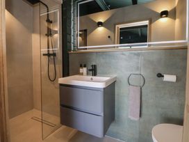 A bathroom with shower, sink, and toilet at The Larch House in Farndon