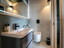 A bathroom with a sink and toilet at The Larch House in Farndon