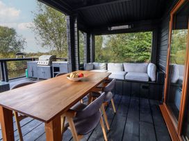 An outdoor dining area with a table and seating at The Larch House Farndon