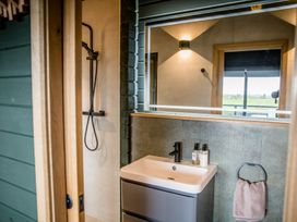 A bathroom with a shower and sink at The Larch House in Farndon