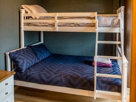 A bunk bed with sheets and pillows at The Larch House Farndon
