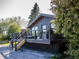 A house with a deck and stairs at The Larch House in Farndon