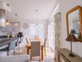 A dining room with a table and chairs at Cedar 1 Pinewood Retreat