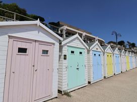 A row of colorful beach huts at Cedar 1 Pinewood Retreat