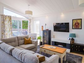 A living room with a sofa and television at Cedar 1 in Pinewood Retreat in Rousdon near Lyme Regis