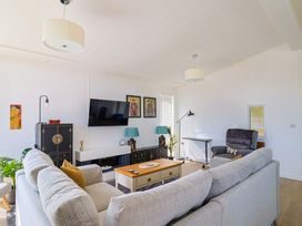 A living room with a television and a sofa at Cedar 1, Pinewood Retreat in Rousdon near Lyme Regis