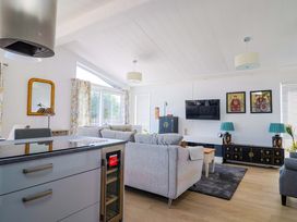 A living room with a sofa and television at Cedar 1 Pinewood Retreat in Rousdon near Lyme Regis